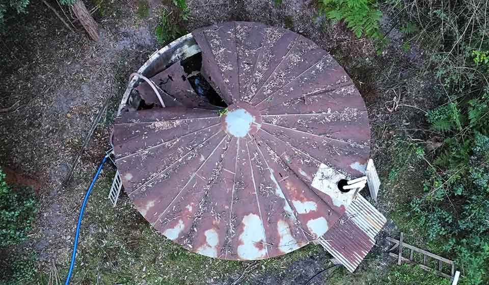 Water tank with roof in need of repair